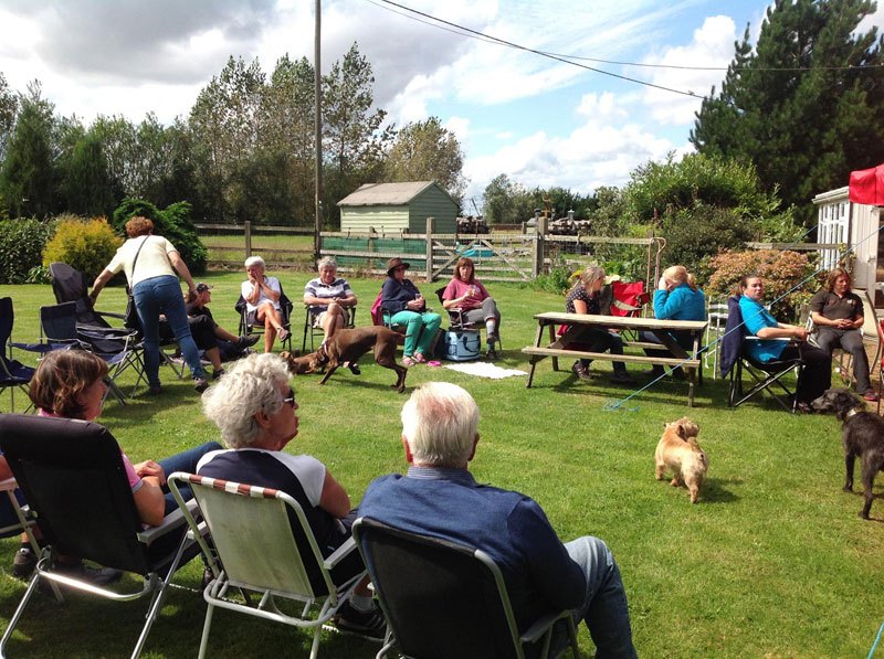 Photo of club members relaxing at a club barbeque